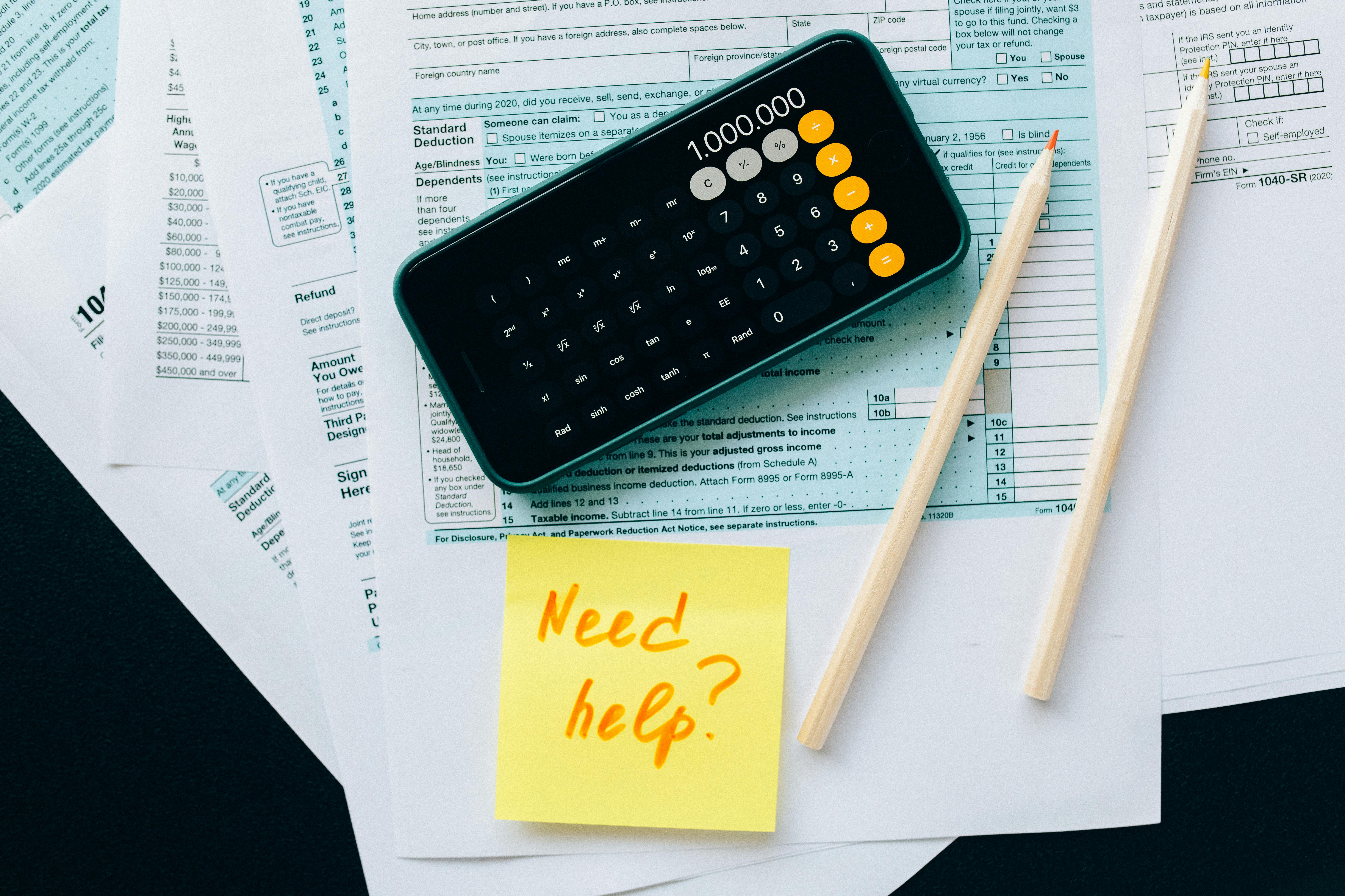 financial papers with a calculator, pencils, and a note saying 'Need help?' Great insights deserve great grades.